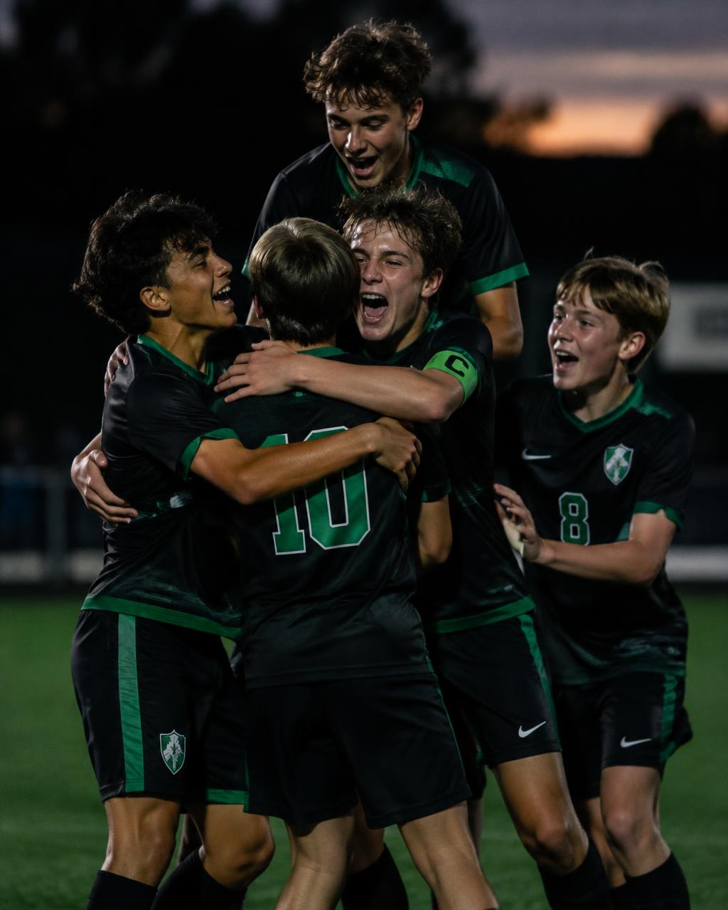 Teammates celebrating a goal together